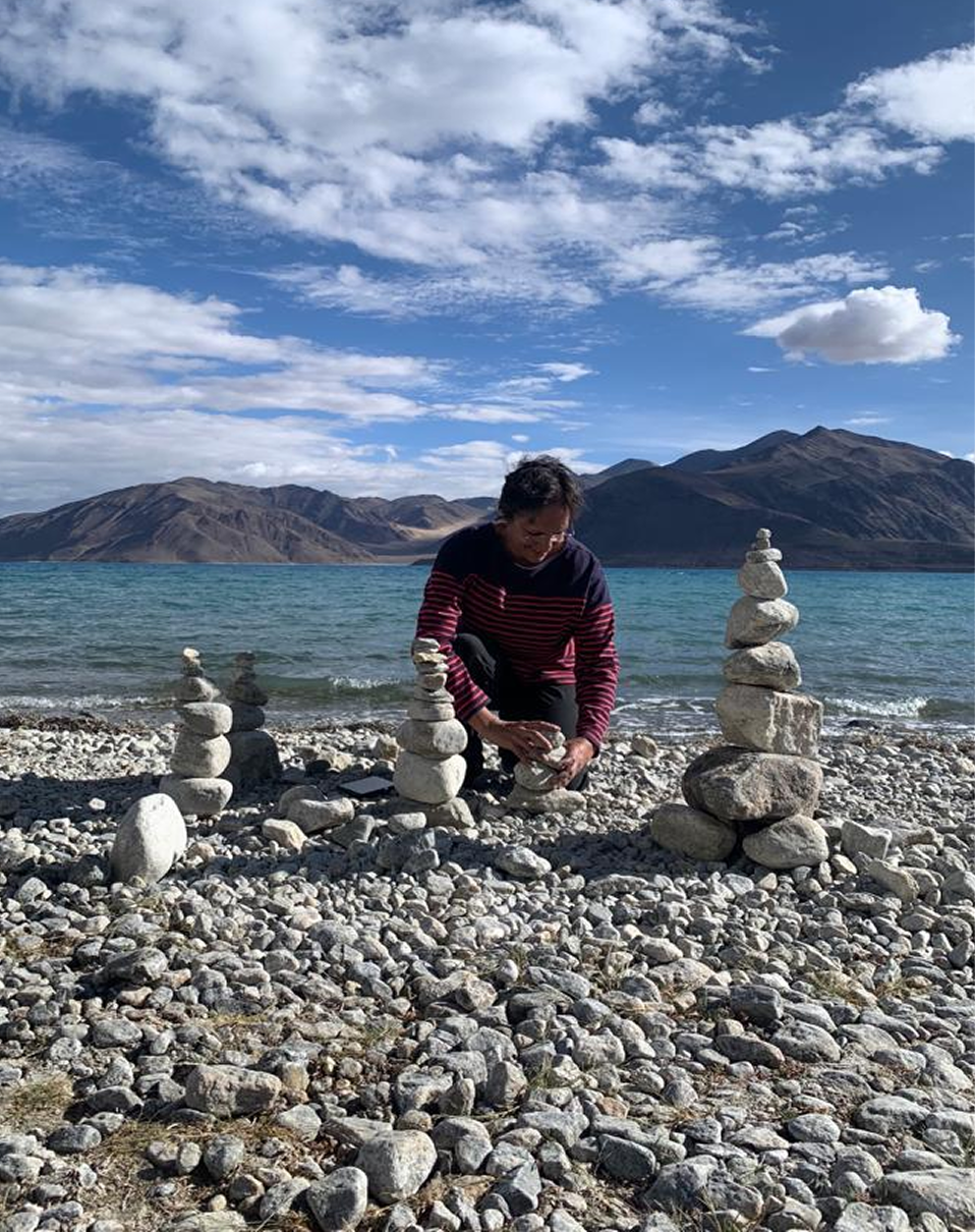 Balancing stones by a lake